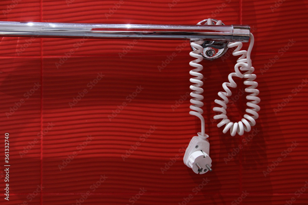 Bathroom rail with a plug. The electric radiator is not plugged in. Bathroom rail with a plug. The electric radiator is not plugged in.