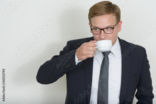 Portrait of businessman with blond hair drinking coffee