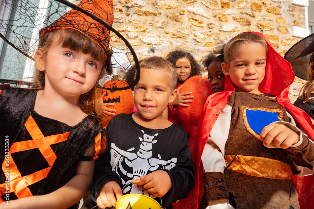 Φωτογραφία Portrait of a boy in the group of Halloween costume dressed kids standing togeth