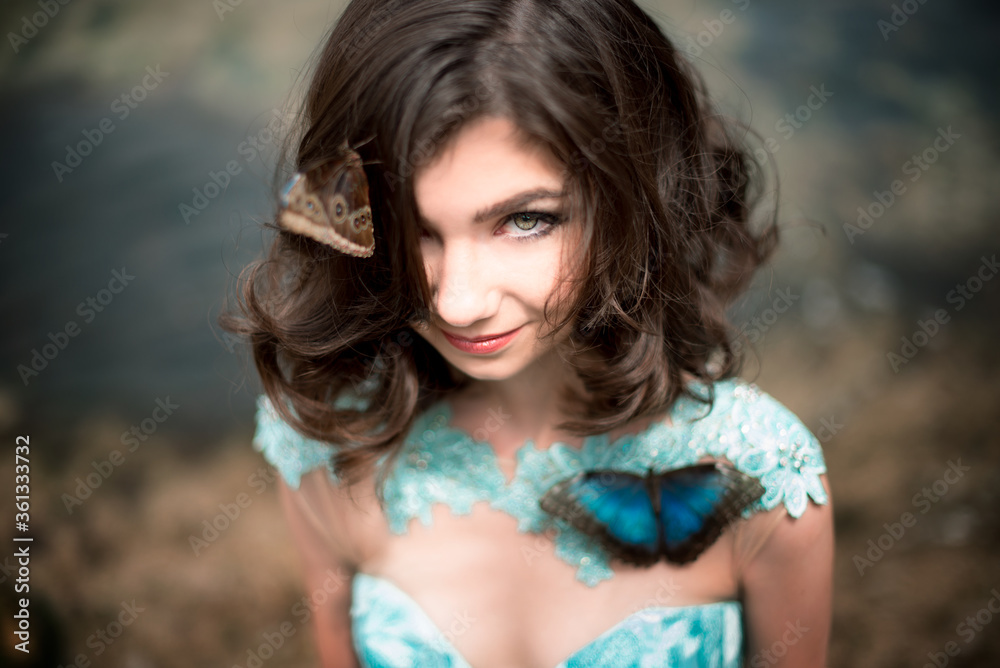 Beautiful young girl in a dress with butterflies on the beach. Portrait Beautiful young girl in a dress with butterflies on the beach. Portrait