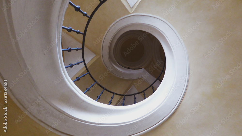 Fototapeta premium Up the stairs in a circle. Ceiling cream