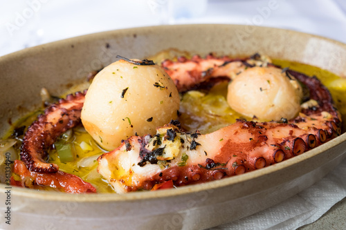 Traditional portuguese dish popular on Madeira island - polvo a lagareiro, octopus with baked potatoes and olive oil.