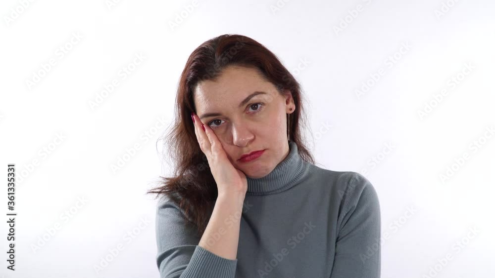 Cheek gesture. Boredom gesture. Brunette caucasian woman using her hand to support head - it's signal that boredom has become. Cheek gesture. Boredom gesture. Brunette caucasian woman using her hand to support head - it's signal that boredom has become.