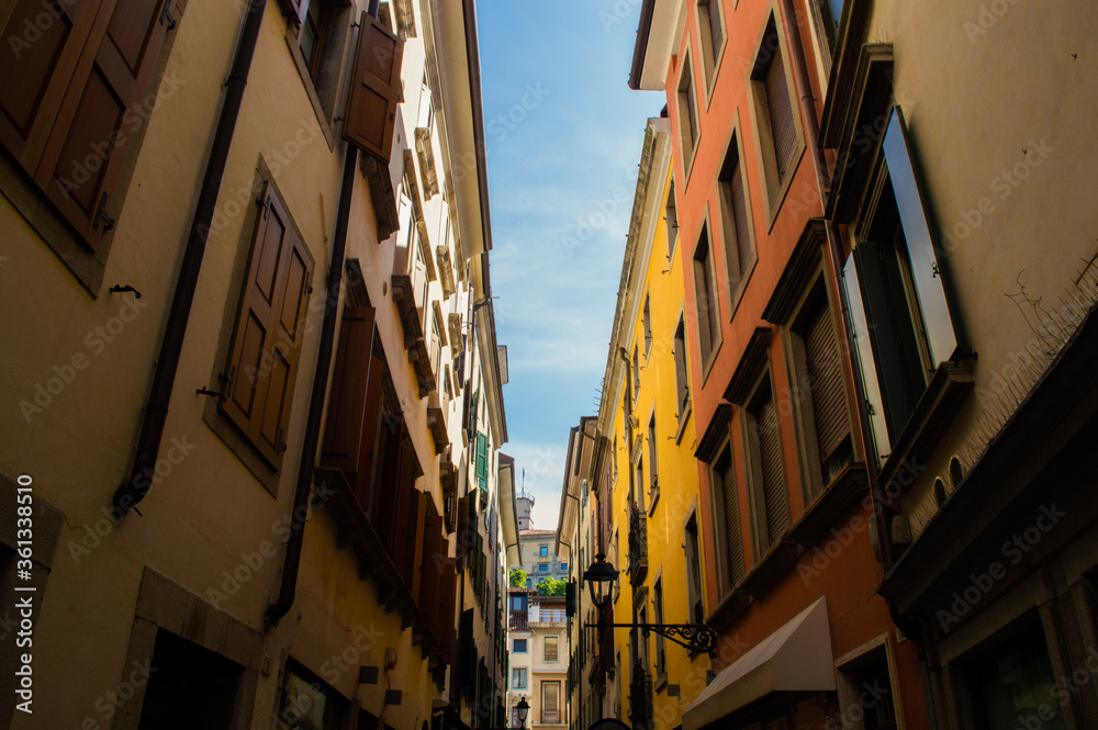 Narrow Italian street with colorful houses.