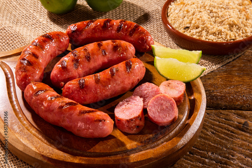 Grilled sausage. Grilled Sausage on wooden board. Brazilian barbecue. photo