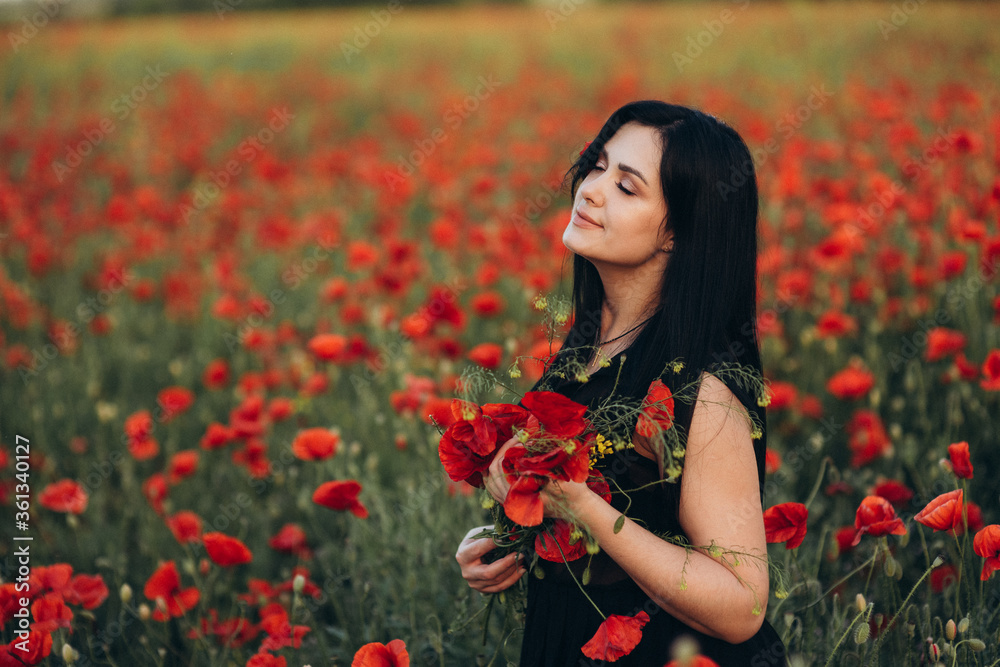 Portrait of a beautiful cute brunette girl in poppy field at sunset Portrait of a beautiful cute brunette girl in poppy field at sunset