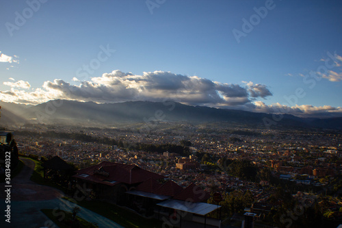 Panoramic view of a sunny and colorful sunset with clouds over the city of Cuenca Ecuador