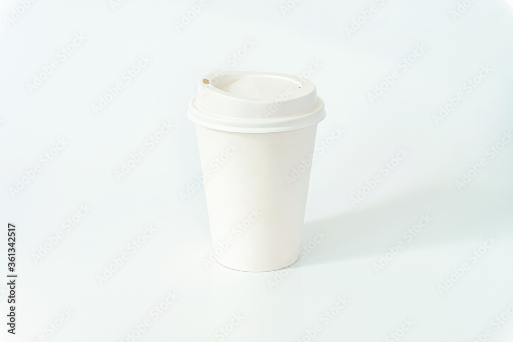 White disposable paper coffee cup with plastic lid isolated on white background White disposable paper coffee cup with plastic lid isolated on white background
