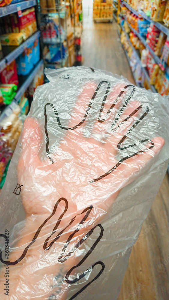 Shopping in a store with plastic gloves during Covid 19 pandemic in Genoa, Italy.