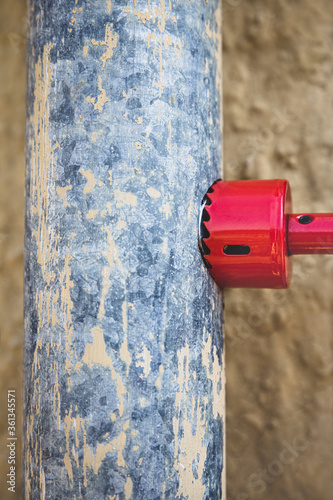 A hole is drilled into a downspout photo