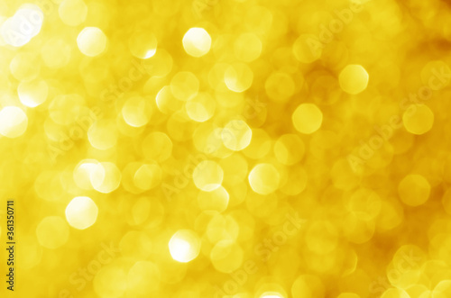 abstract defocused yellow bokeh sparkling light glitter background. for wallpaper backdrop and template.