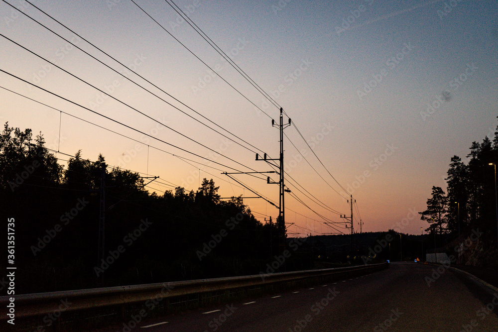 Summer sunset with the train wires. Power lines. sunset.