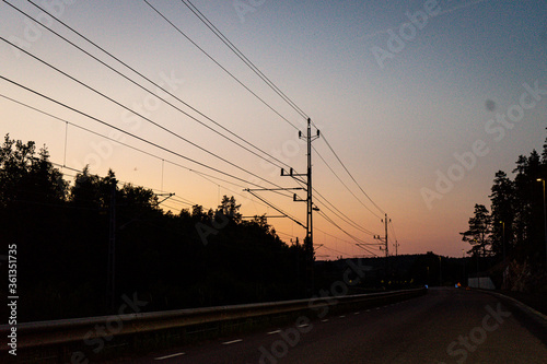 Summer sunset with the train wires. Power lines. sunset.