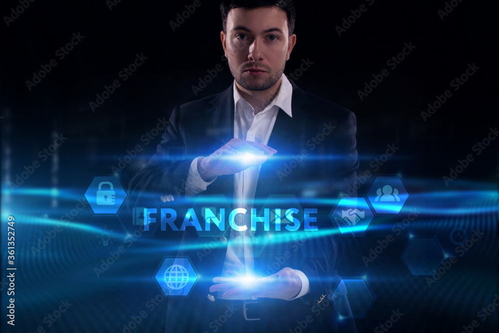 Business, Technology, Internet and network concept. Young businessman working on a virtual screen of the future and sees the inscription: Franchise Business, Technology, Internet and network concept. Young businessman working on a virtual screen of the future and sees the inscription: Franchise