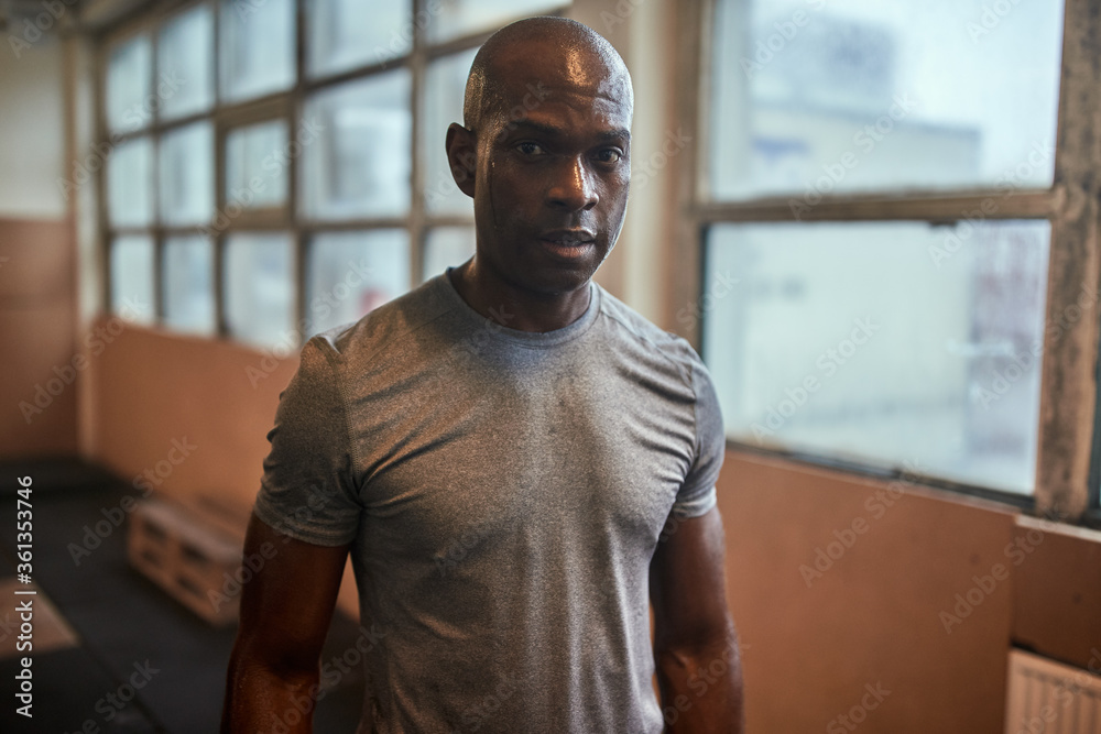 Fit young man sweating after an intense gym workout Fit young man sweating after an intense gym workout