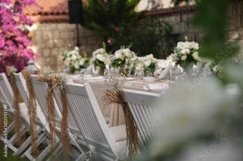 Fototapeta Naklejka Na Ścianę i Meble -  Dining table chair flower decoration, chair decor