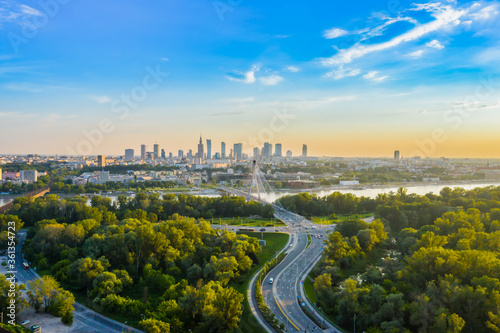 Beautiful panoramic aerial drone view to the Center of modern Warsaw city with silhouettes of skyscrapers in in the rays photo