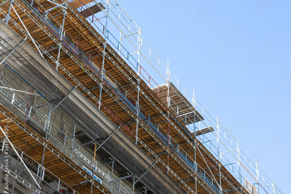 Building skyscrapers or multi-storey building in scaffolding poles. Special construction for workers safety