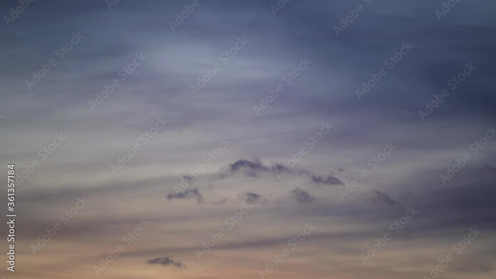 Fast motion formation of a beautiful and peculiar lonely cloud in an orange and pink sky at dawn. Fast motion formation of a beautiful and peculiar lonely cloud in an orange and pink sky at dawn.