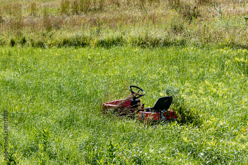 lawn tractor on overgrown grass