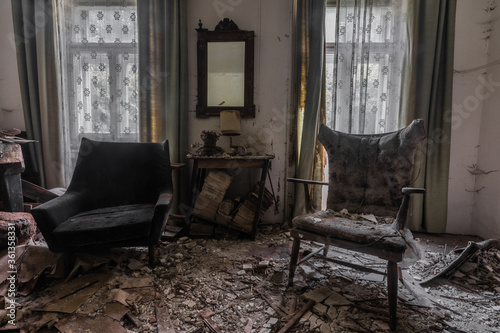 two armchair and a table with a mirror in a room