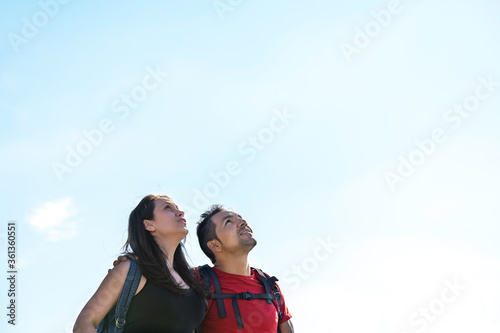 Couple hiking in the mountains looking at the sky