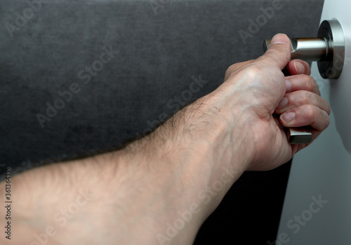 Close-up of a man opening the door.