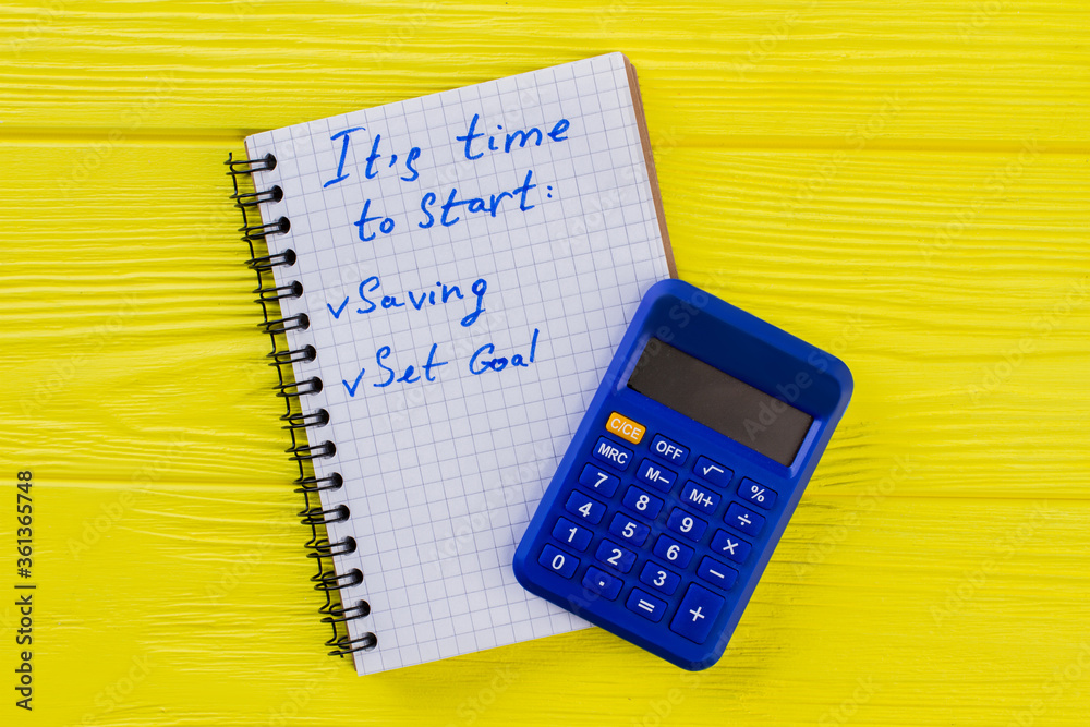 Finance and accounting concept. Calculator with notepad on yellow wood. Finance and accounting concept. Calculator with notepad on yellow wood.