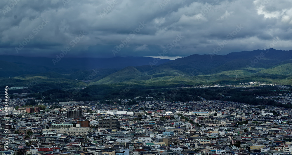 View of the edge of Hakodate, in northern Japan, with stormy mountains visible on the horizon View of the edge of Hakodate, in northern Japan, with stormy mountains visible on the horizon