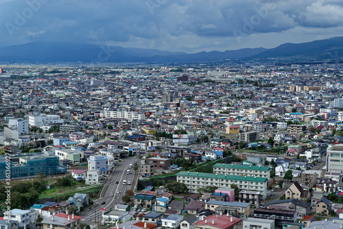 View of the suburbs of Hakodate, in northern Japan, with low mountains visible in the distance