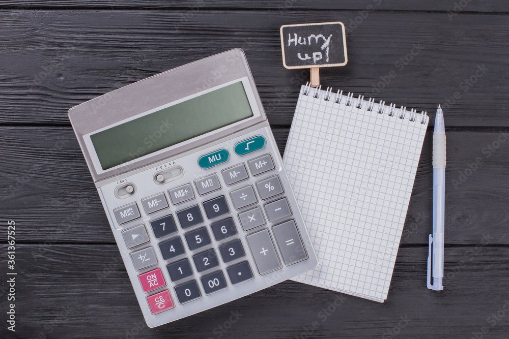 Calculator with notepad and pen flat lay. Top view close up. Dark wooden background. Calculator with notepad and pen flat lay. Top view close up. Dark wooden background.