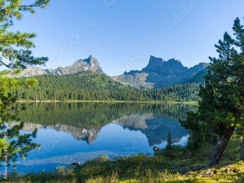 Light lake in the Ergaki nature park. Siberian mountains of the Sayan Mountains. View of the peaks of  Bird  and  Star 