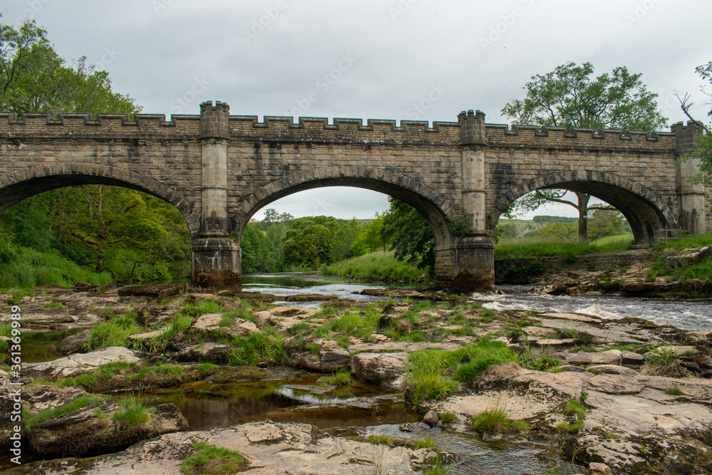 Three-arched medieval bridge and river
