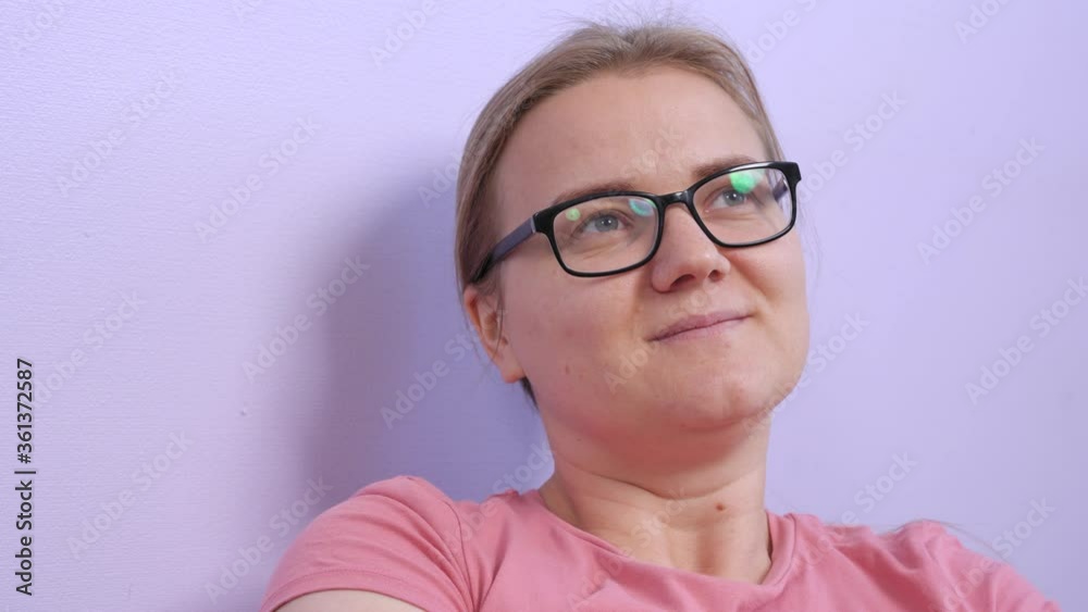 Attractive blonde girl with poor eyesight in glasses looked away thoughtfully and shook head in agreement, raising eyebrows. Concept of gestures and expression of emotions. Attractive blonde girl with poor eyesight in glasses looked away thoughtfully and shook head in agreement, raising eyebrows. Concept of gestures and expression of emotions.