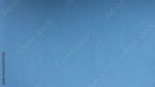 plain blue background with a light grainy dotted structure and a flat surface as the basis for design and creativity