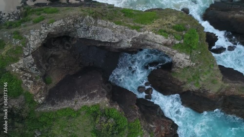 Revealing aerial shot of sea caves in Crescent Head National Park photo