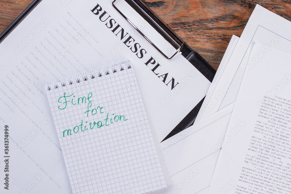 Flat lay different paper document and notebook. Time for motivation written on notepad. Flat lay different paper document and notebook. Time for motivation written on notepad.