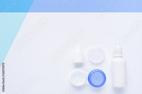 contact lens case on white and blue background, with copy space.