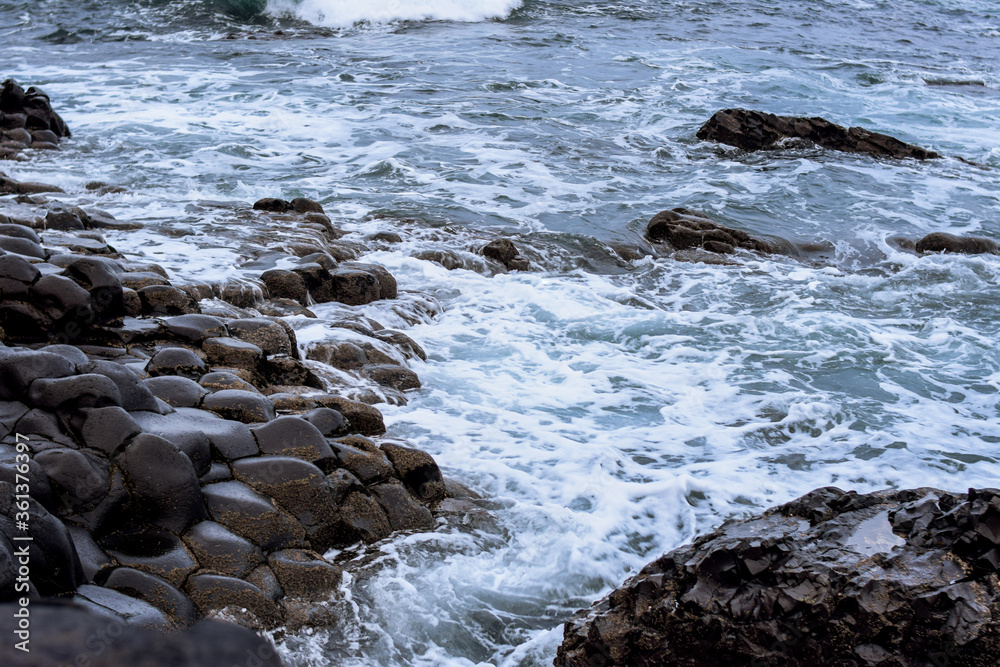 Photo of the rocks in the beach during winter in the Giants Causeway in Belfast, Northern Ireland