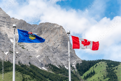 Canadian and Alberta flags waiving on a beautiful summer day in Kananaskis.  photo