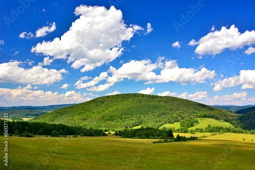 Beautiful summer landscape in the mountains with green meadows and forested hills, Low Beskids (Beskid Niski), Poland 