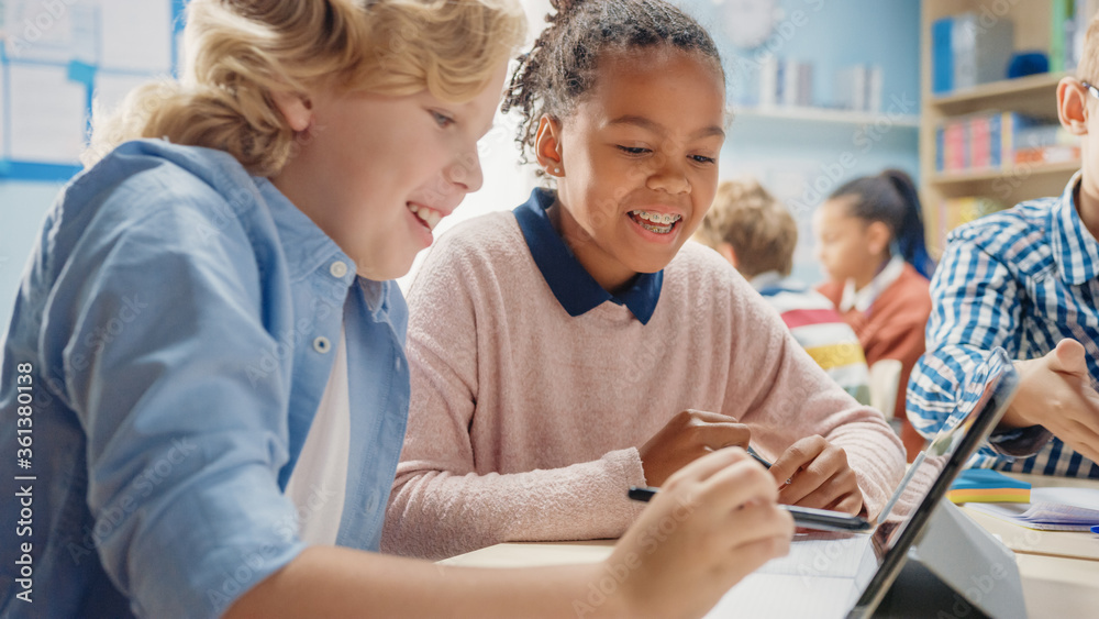 In the Elementary School: Girl and a Boy Work as a Team Using Tablet Computers, Learning Programming Language, Internet Safety and Robotics Design. Progressive Education System In the Elementary School: Girl and a Boy Work as a Team Using Tablet Computers, Learning Programming Language, Internet Safety and Robotics Design. Progressive Education System
