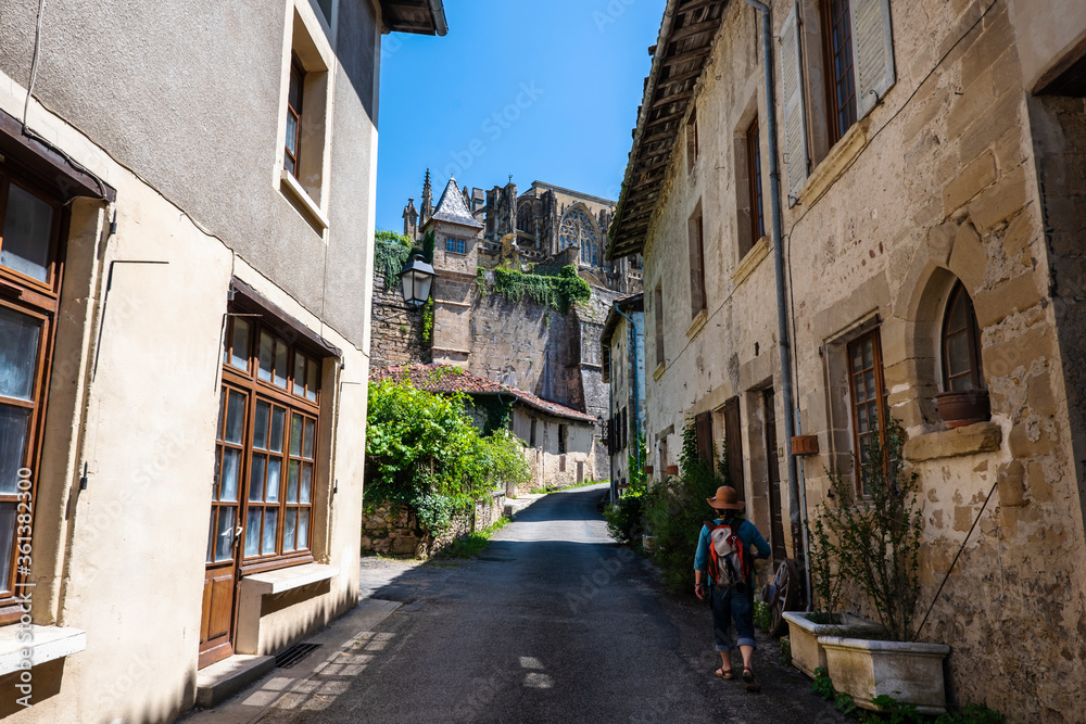 Medieval street of the most beautiful french village of Saint-Antoine-l'Abbaye with a tourist walking up the old center. France 2020.
