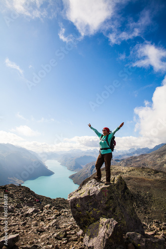A very happy hiker standing on a rock in Jotunheimen, Norway