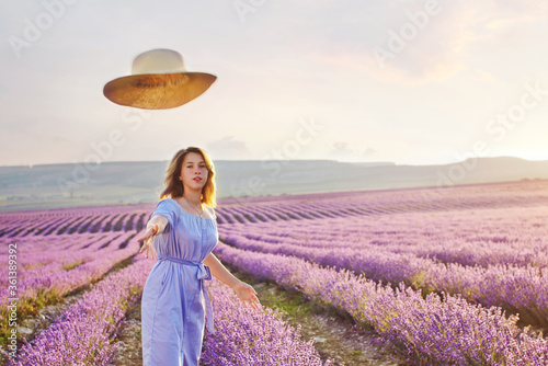 pretty teen girl walking in lavender field