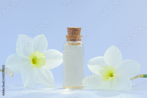 Essence of flowers on white in beautiful glass jar