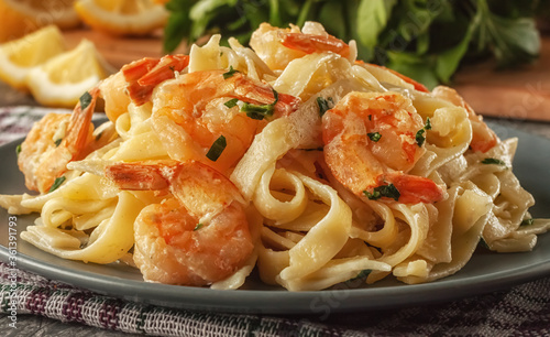 Tagliatelle with prawns and parsley on a gray background