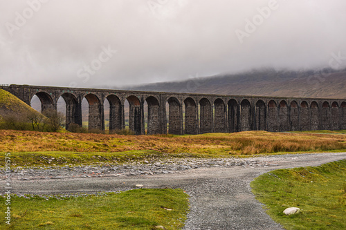 Photo of an impressive and big Ribblehead Viaduct in the middle of nature in UK