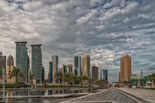 Doha  Qatar  Skyline daylight view from Sheraton park with reflection in the water and clouds in sky in background