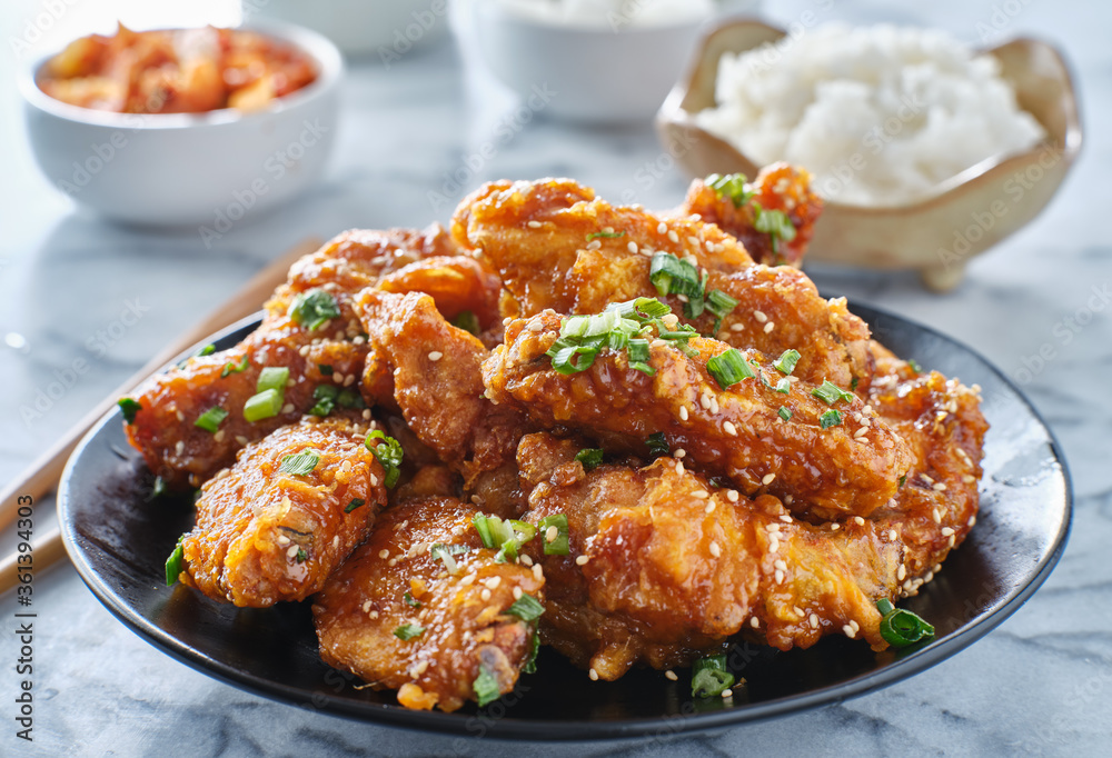 crispy fried korean chicken wings in galbi sauce with pickled radish, kimchi, and rice side dishes crispy fried korean chicken wings in galbi sauce with pickled radish, kimchi, and rice side dishes